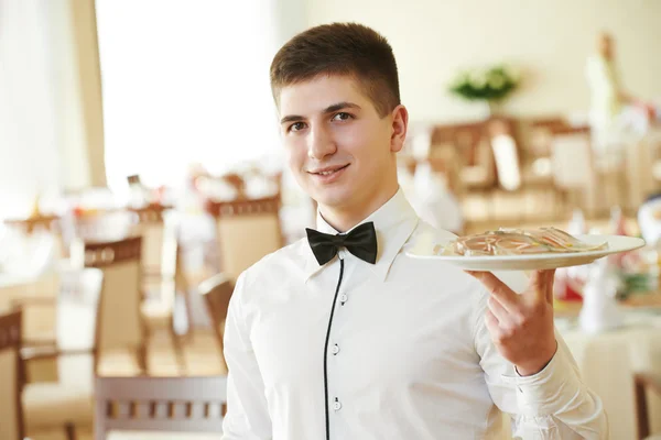 Waiter man with tray at restaurant