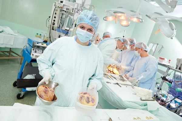 Surgeons nurse at cardiac surgery operation