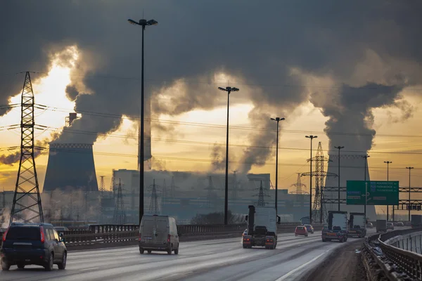 SAINT-PETERSBURG City ringway with cars and air pollution from heat electric generation plant in Saint-Petersburg