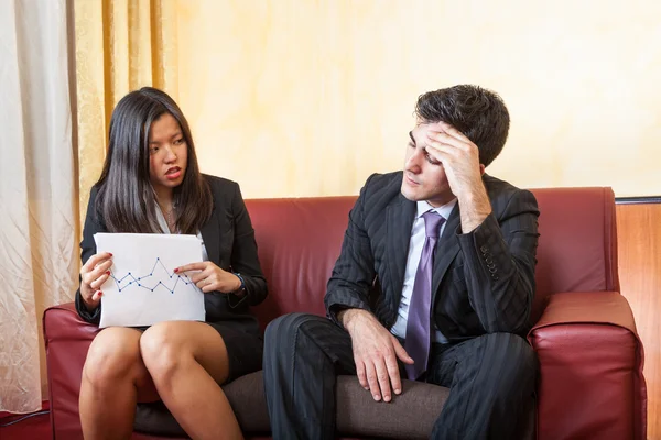 Sad Business Couple on the Sofa