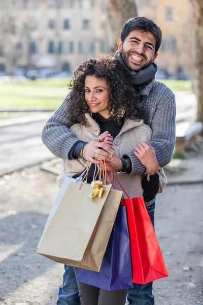 Happy Young Couple with Shopping Bags — Stock Photo #25338369