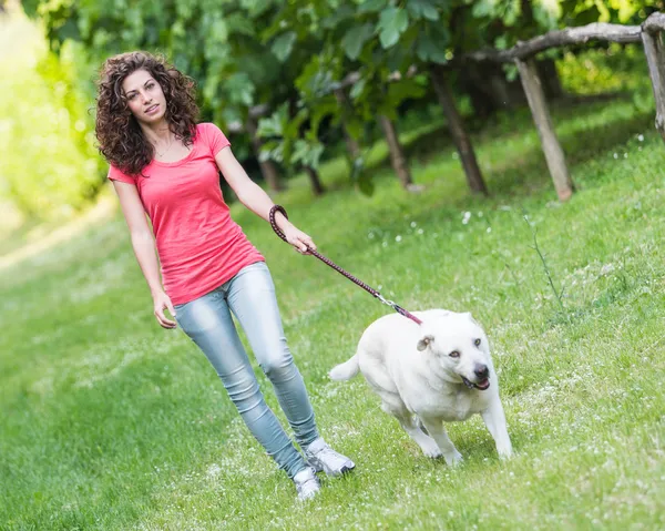 Young Woman Walking with Her Dog