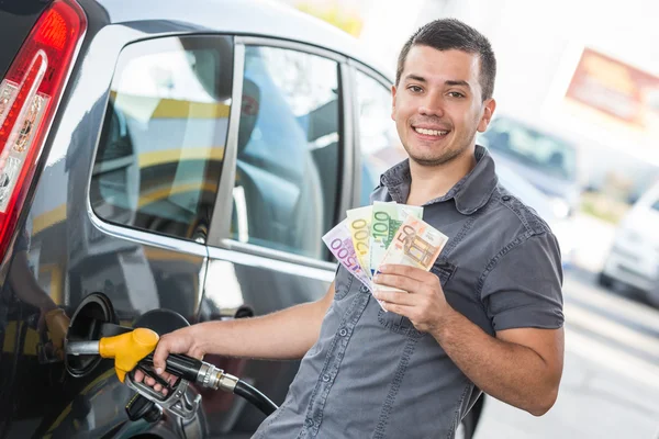 Man with Banknotes at Gas Station