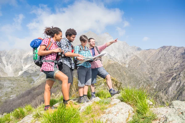 Hikers Looking at Map on top of Mountain