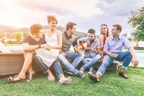 Group of Friend Singing Together next to Swimming Pool