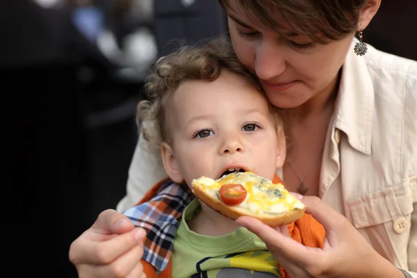 Toddler eating bruschetta