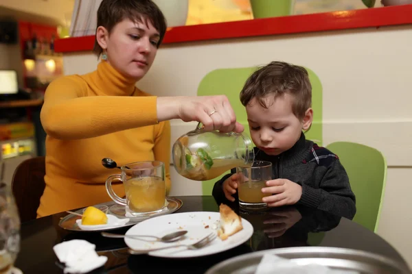 Mother pouring juice