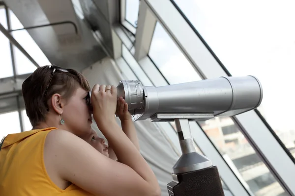 Family looking through pay binoculars