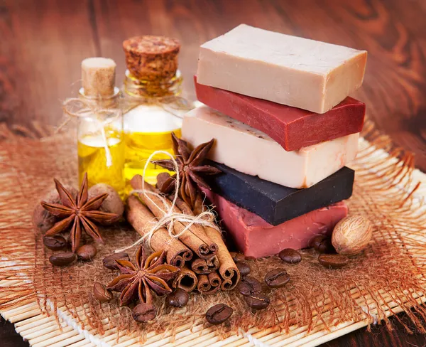 Handmade soap, oil in bottles anise and cinnamon on the table