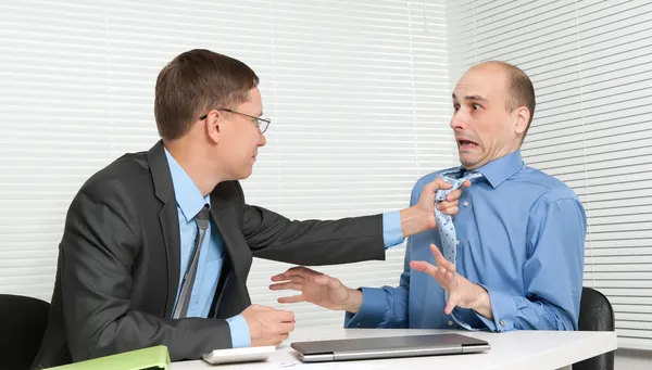 Business fighting at the desk in office