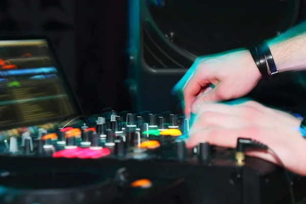 DJ hands on sound equipment