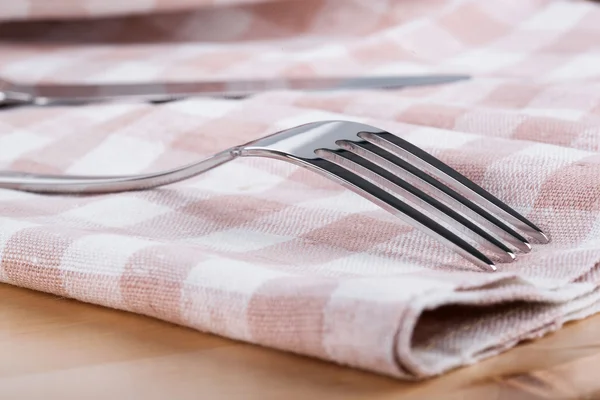 Fork and knife on towel
