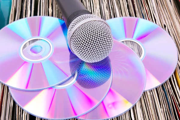 Microphone and compact disks on vinyl records