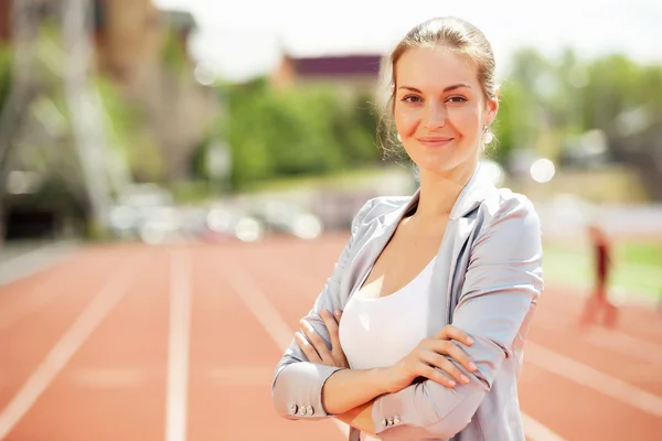 Businesswoman sport manager and executive at athletic stadium and race track