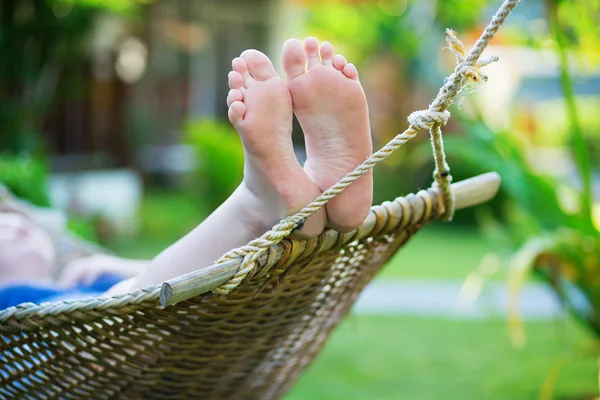 Woman relaxing in hammock on a tropical resort