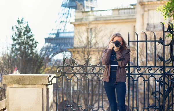 Young girl taking a street photo in Paris
