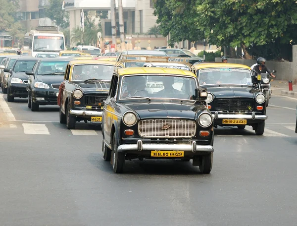 Mumbai traffic with several classical ambassador cabs,it is unique style of taxi,India