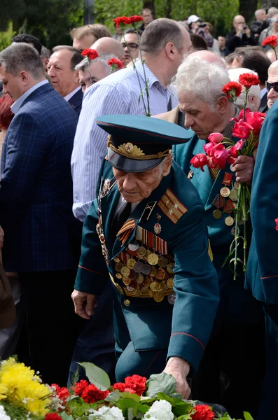 Old soldier come put flowers to Eternal Flame during celebration Victory Day,Odessa,Ukraine