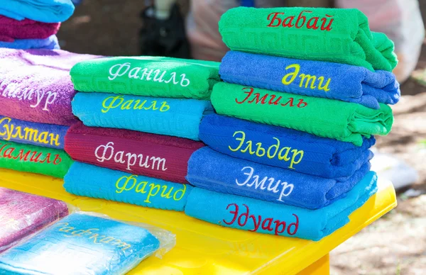 Stack of the multi colored towels with names on tatar language