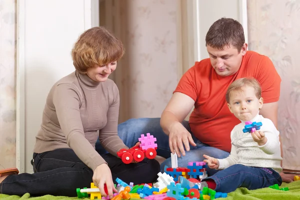 Happy family plays in home interior