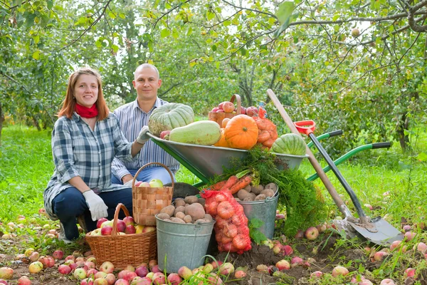 Family with harvest in garden