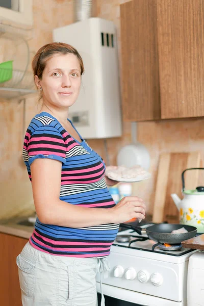 Pregnant woman cooking food