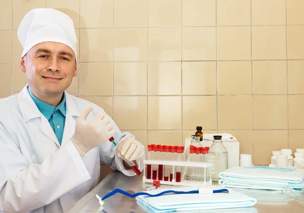 Male nurse works with blood sample
