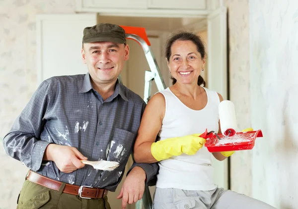 Happy woman and man makes repairs