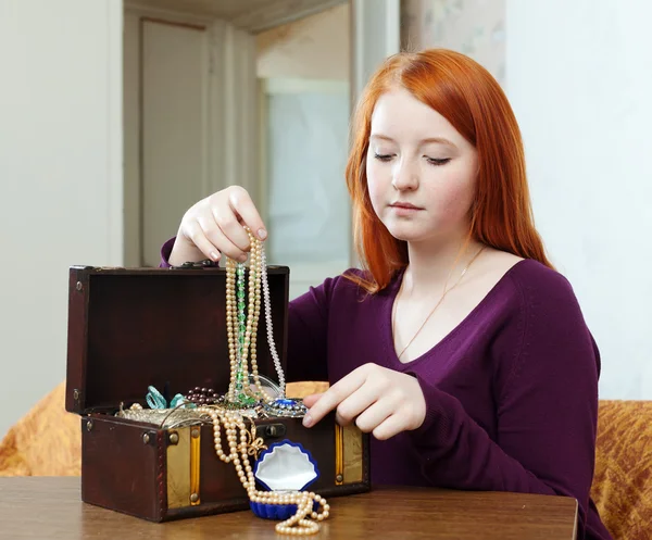 Portrait of teen girl chooses jewelry