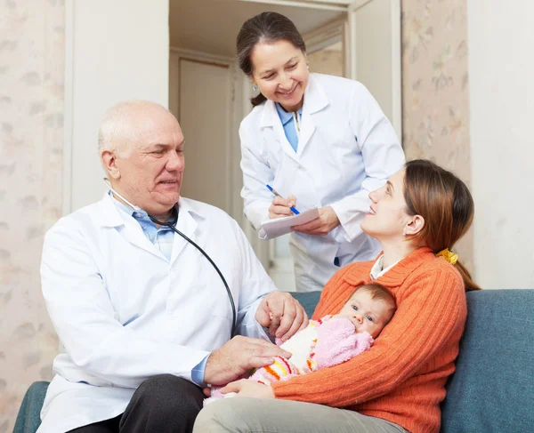 Male pediatrician doctor talks with mother of newborn