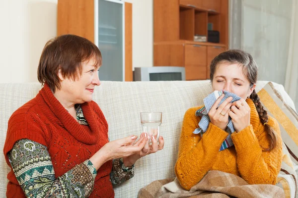 Mature woman caring for her adult daughter has cough