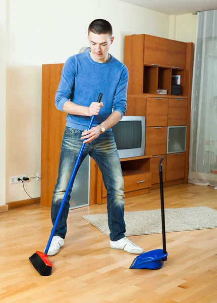 Man  sweeping the floor  at home