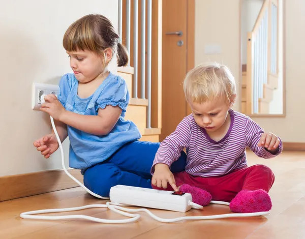 Children playing with electrical extension