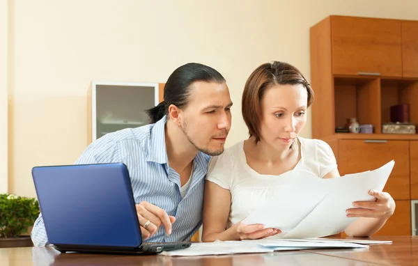 Couple staring financial documents