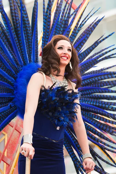 Woman in blue feathers at Gay pride parade