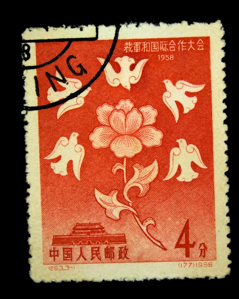 CHINA - CIRCA 1958: A stamp printed in China shows five pigeons flying around a flower on the background of the Forbidden City, circa 1958