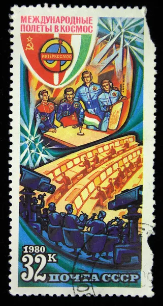 USSR - CIRCA 1980: A stamp printed in tne USSR shows Soviet-Hungarian space station crew and Mission Control Center, circa 1980