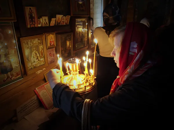 Woman puts a memorial candle