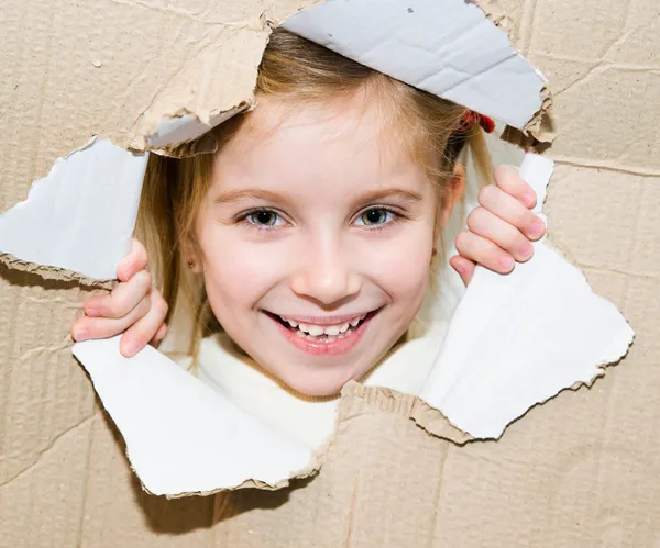 Kid in torn paper hole