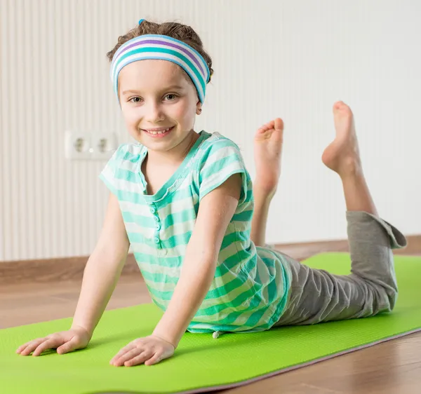 Little girl doing gymnastic exercises