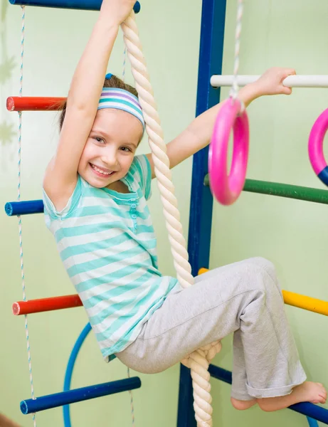 Happy little girl at home gym