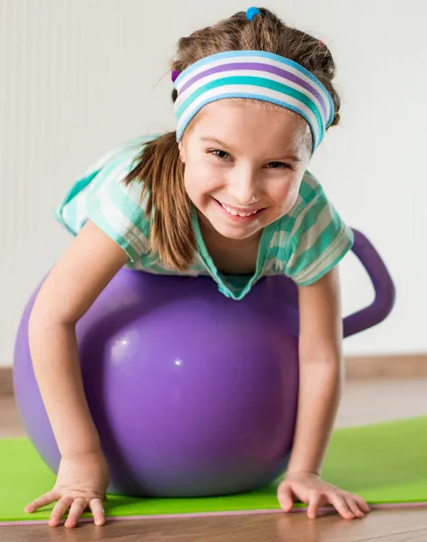 Little girl doing gymnastic exercises