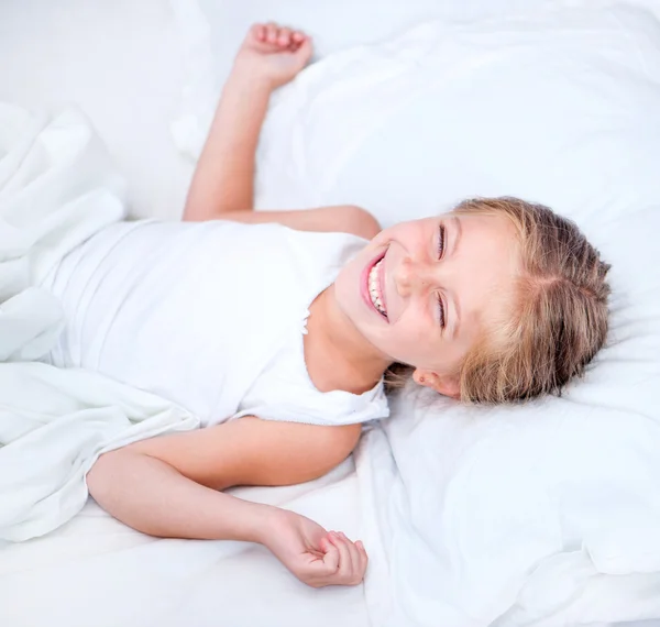 Six year old girl in a white bed
