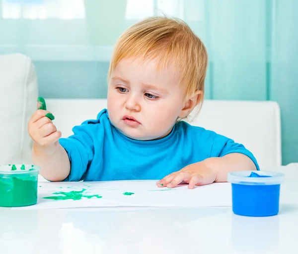 Little girl draw finger paints