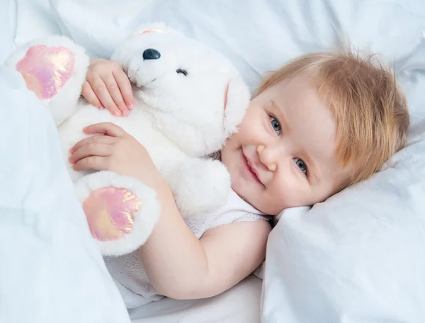Baby lying in a white bed — Stock Photo #35718205