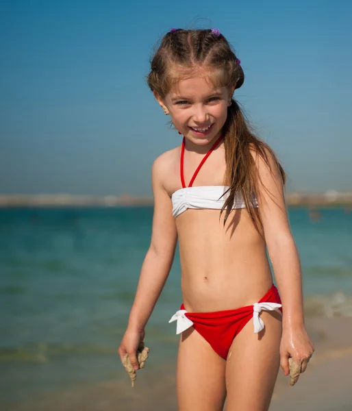 Happy little girl on the beach