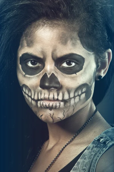 Young woman in day of the dead mask skull. Halloween face art