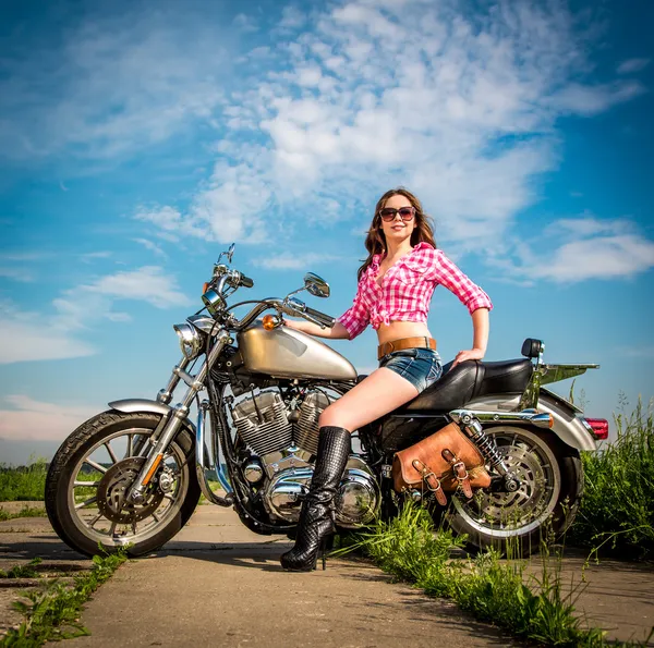 Biker girl sitting on motorcycle