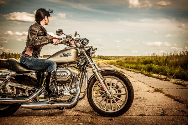 Biker girl and bike Harley Sportster