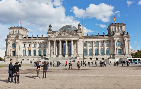 BERLIN, GERMANY - SEPTEMBER 23:Tourists near Reichstag, September 23, 2012, Berlin, Germany. After moving of Bundestag to Berlin in 1999 building of Reichstag was visited by over 13 mil. from all over